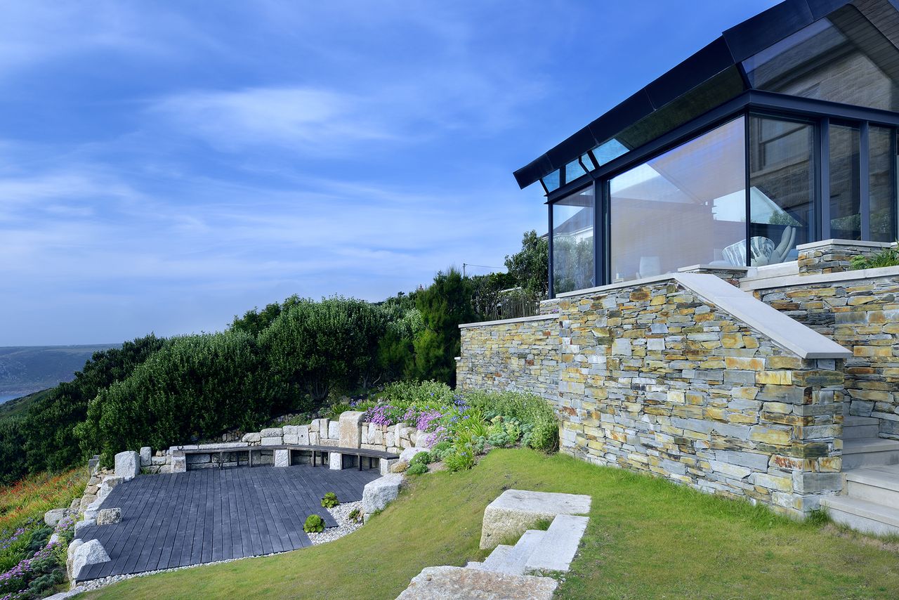 glass extension with landscaped seating area in garden
