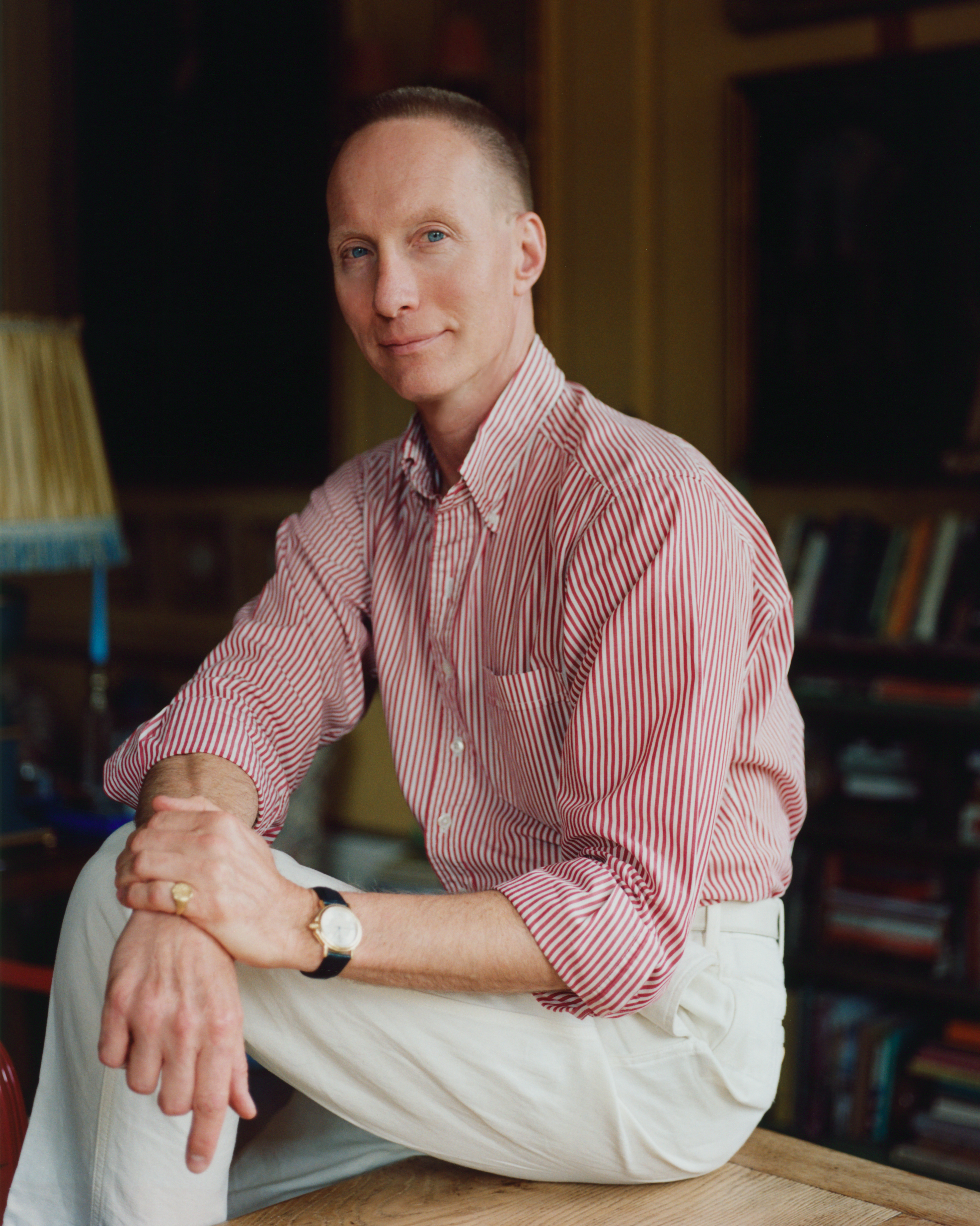 Martin Brudnizki wears white trousers and a striped shirt