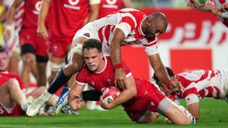 Kieran Hardy fends of a Michael Leitch tackle during a recent Wales vs Japan game