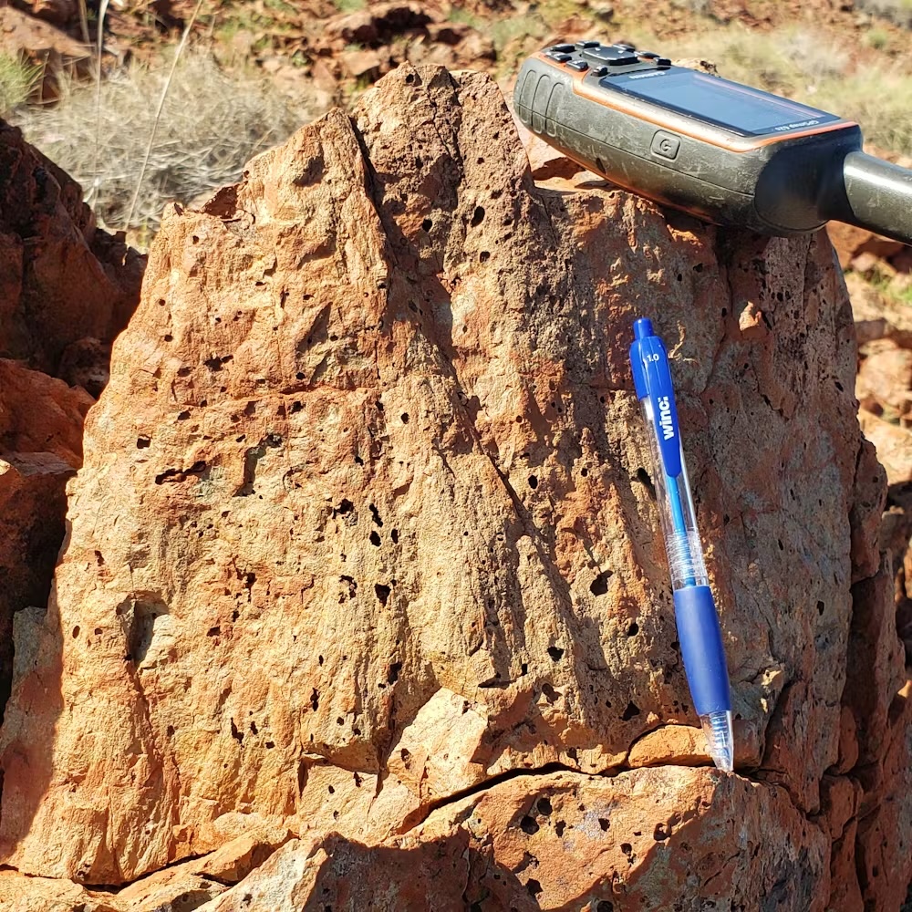 a close-up of a basalt rock with cone-shaped formations