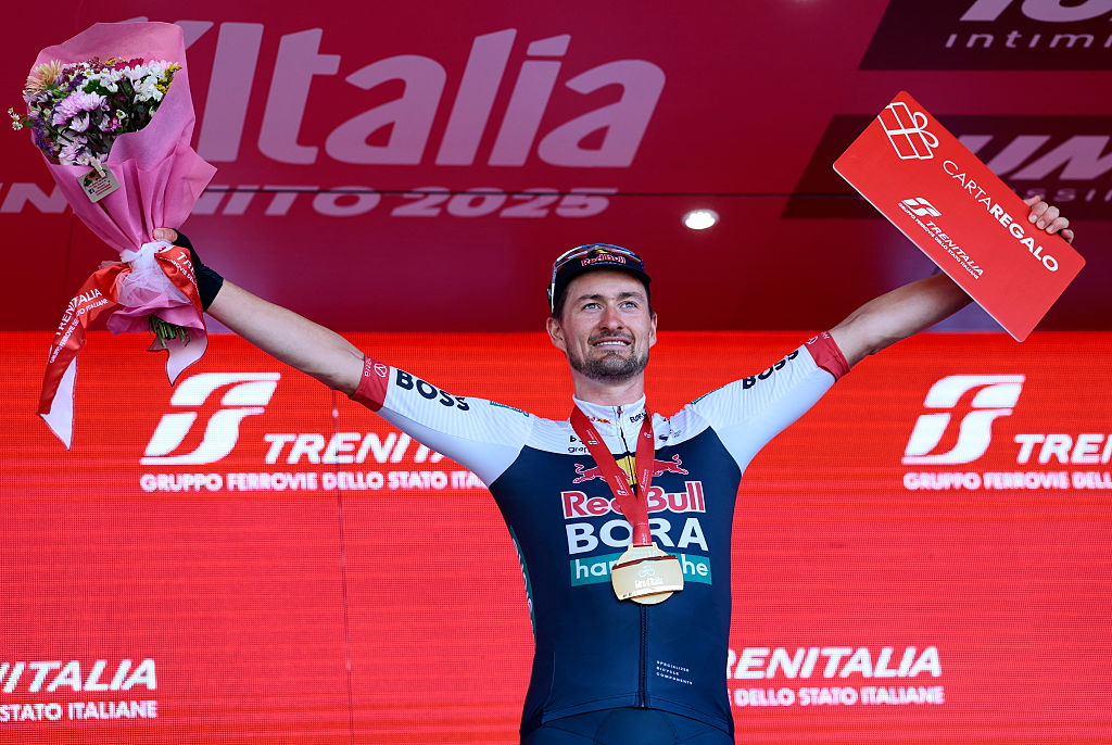 Red Bull-Bora-Hansgrohe's Germany rider Nico Denz celebrates on the podium after wnning the 18th stage of the 108th Giro d'Italia cycling race of 144kms from Morbegno to Cesano Maderno on May 29, 2025. (Photo by Luca Bettini / AFP)