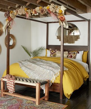 Feathered mirrors and tasseled pieces in a bedroom