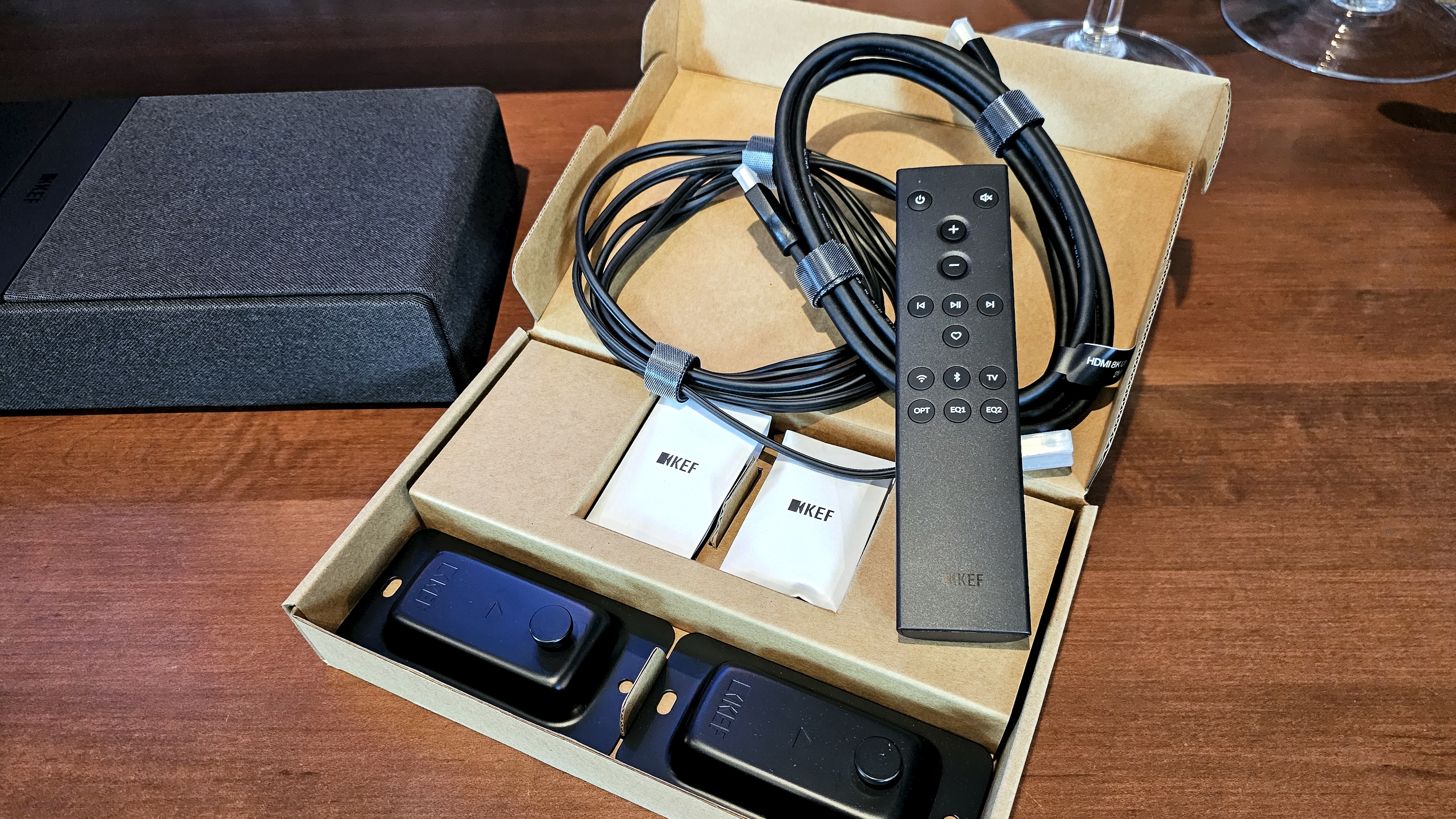 KEF XIO soundbar accessories in box on table