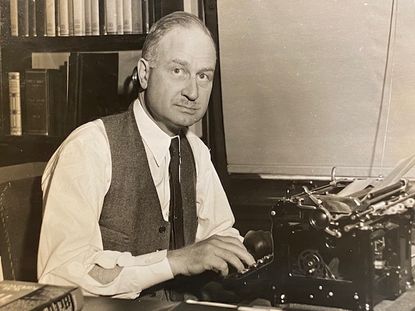 Willard Kiplinger works at his typewriter