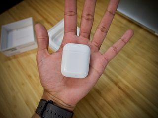 The AirPod case is TINY in my giant hand.