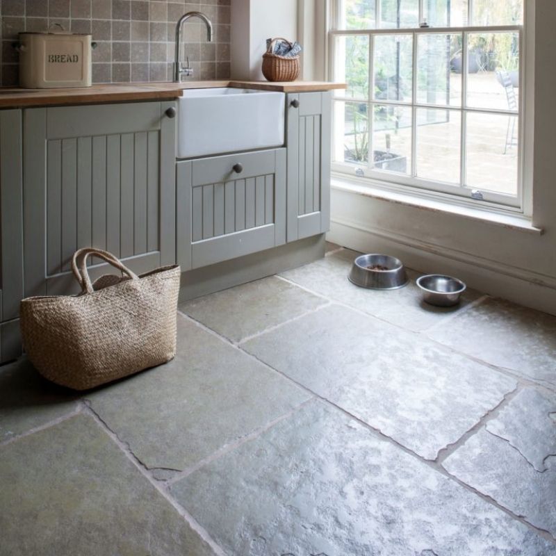 Large format limestone floor tiles in a boot room