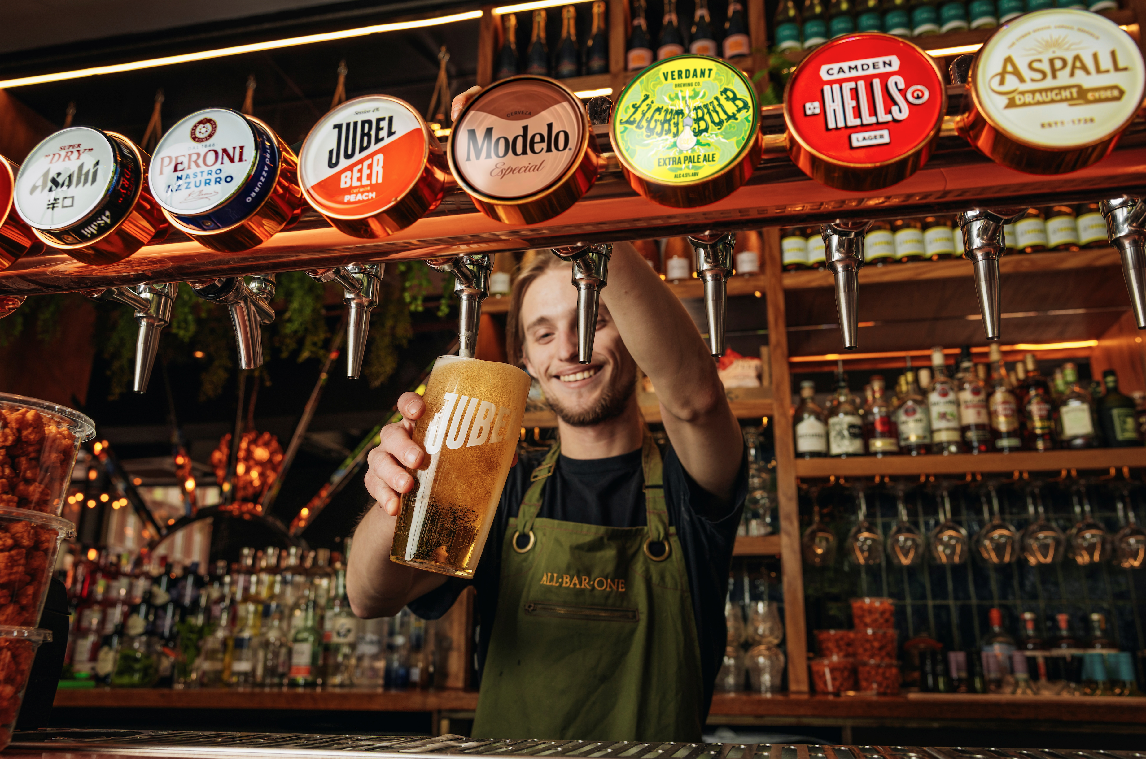 an image of a bartender pulling a pint of Modelo