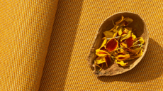 Woven orange fabric with decorative petals