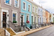Street in residential district with row of coloured houses in London, UK