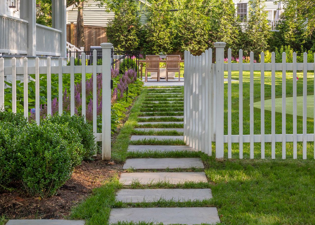 a lawn with a gate in front