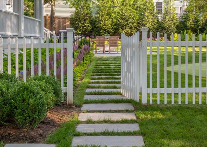 a lawn with a gate in front