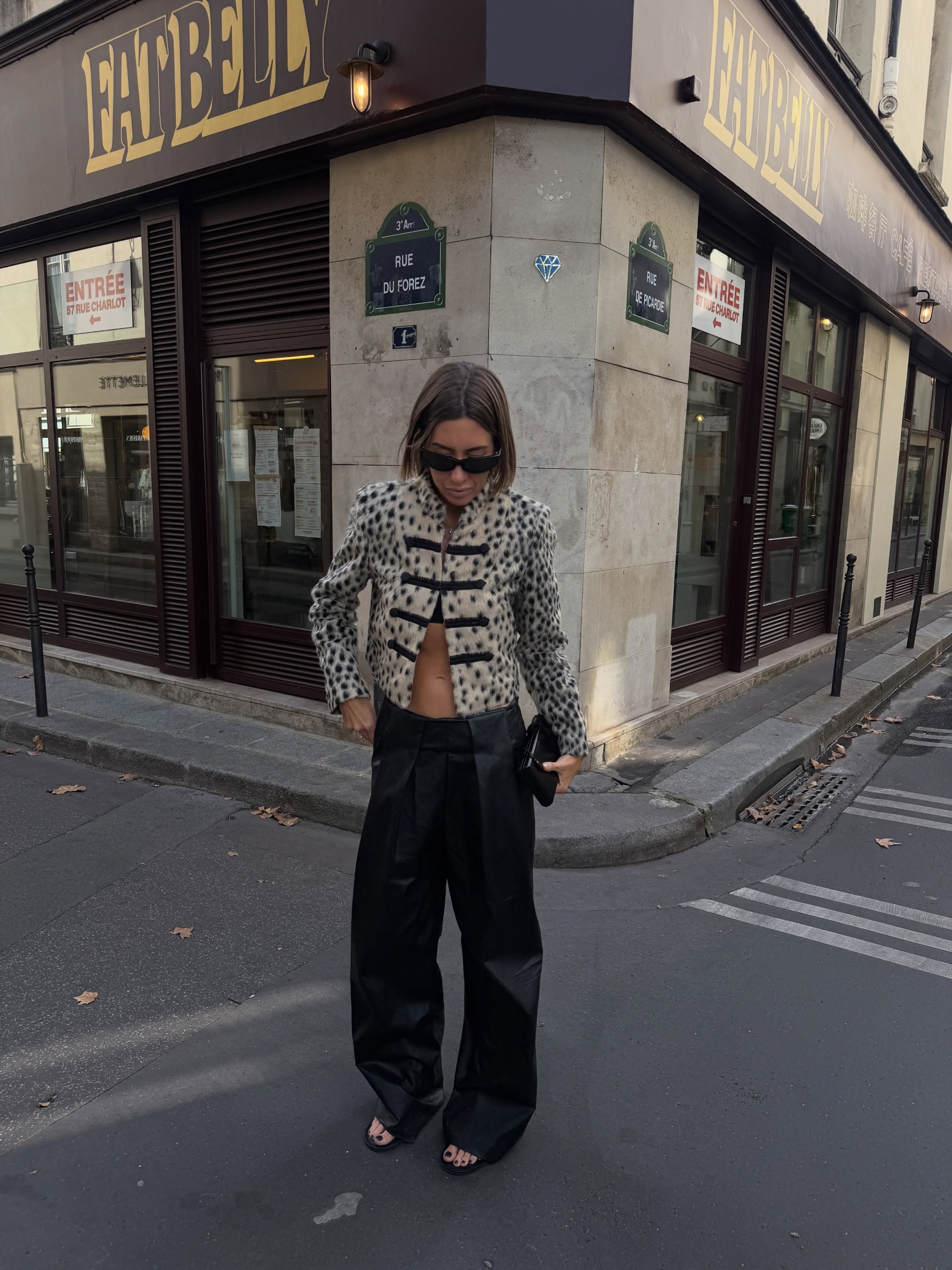 @hannahlewisstylist wears a leopard print jacket with contrasting black frog-tie fastenings with wide-leg trousers