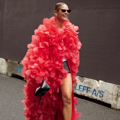 a model wearing a bold 3d flower coat 