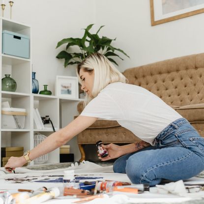 Woman hanging wallpaper