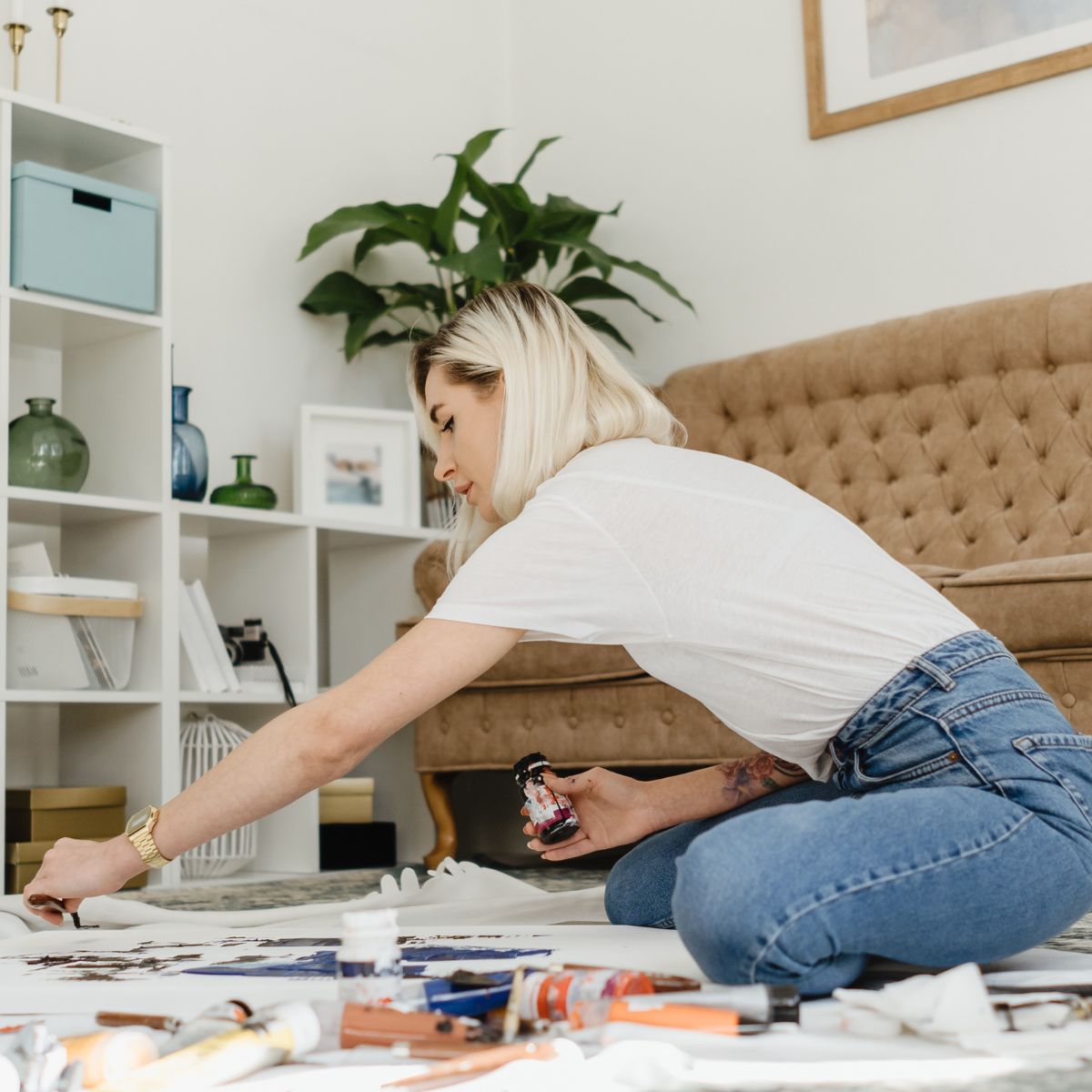 Woman hanging wallpaper