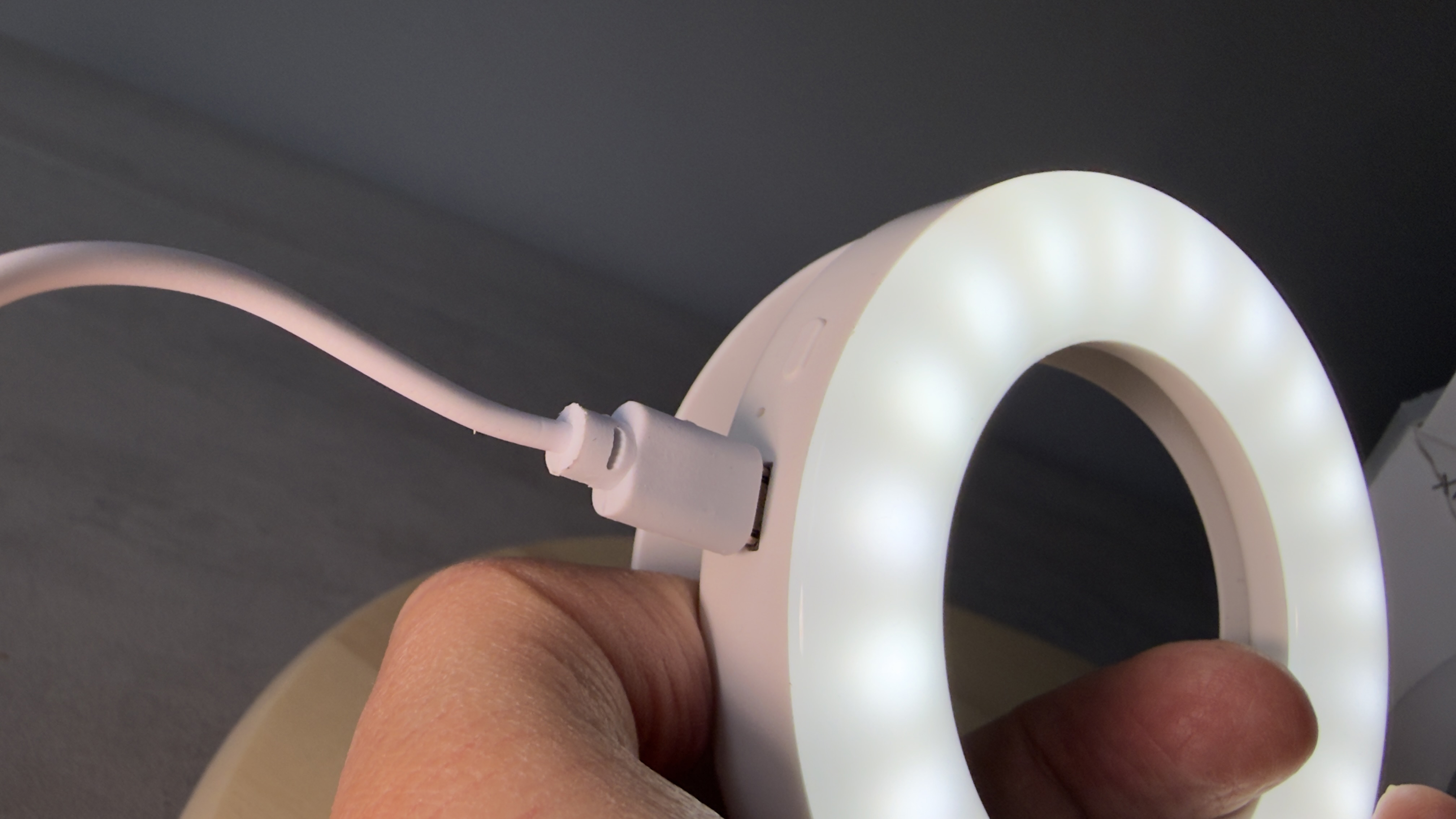 Shot of a white USB-C cable plugged into the power socket of the Selfie Ring Light.