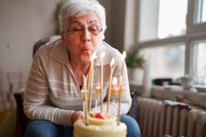 Pensioner blows out candles on birthday cake