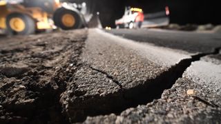 Highway workers repair a hole that opened in the road as a result of the July 5, 2019 earthquake in Ridgecrest, California, about 150 miles (241 kilometers) north of Los Angeles.