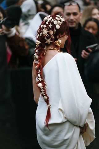 woman with a long red ponytail and shiny hair accessories