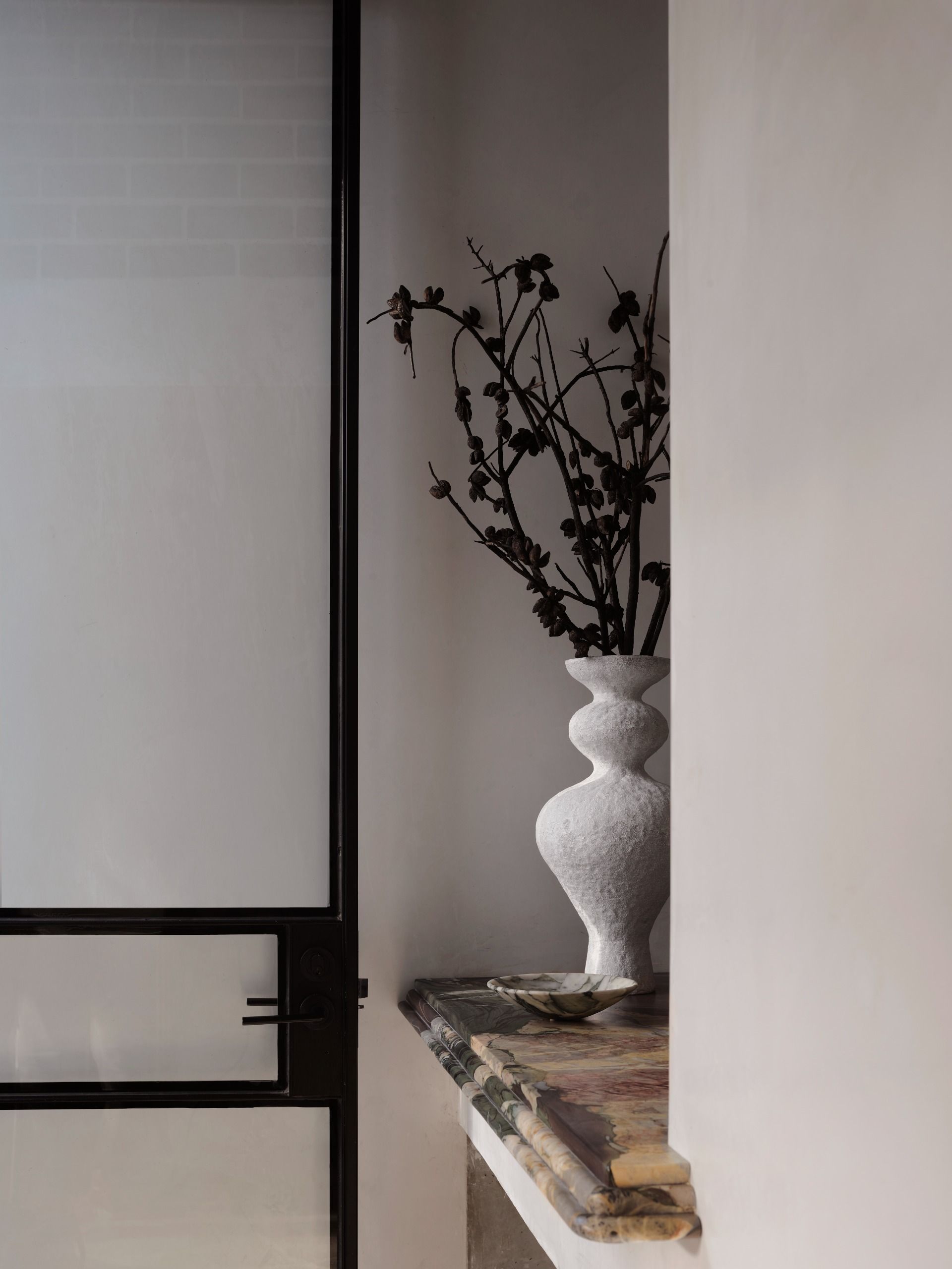 a marble shelf next to a door with a decorative profile
