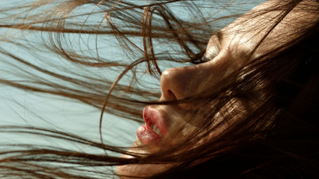 Best products for thin hair: woman with hair blowing in wind