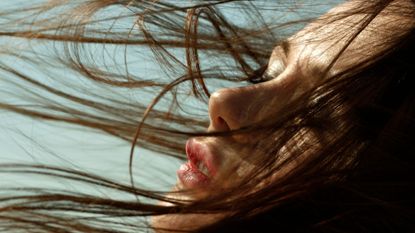 Best products for thin hair: woman with hair blowing in wind