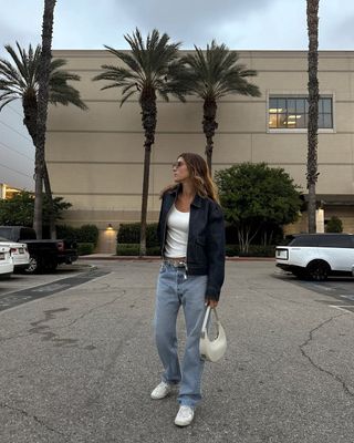 woman wearing white sneakers with denim spring outfit