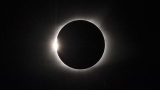 total solar eclipse on Aug. 21, 2017. appearing as a dark circle surrounded by a halo of white light.