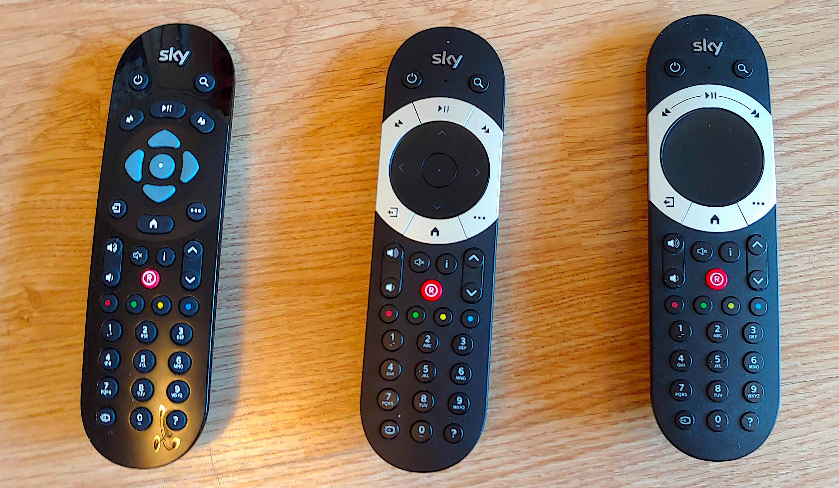 All three versions of the sky q remote on a wooden surface