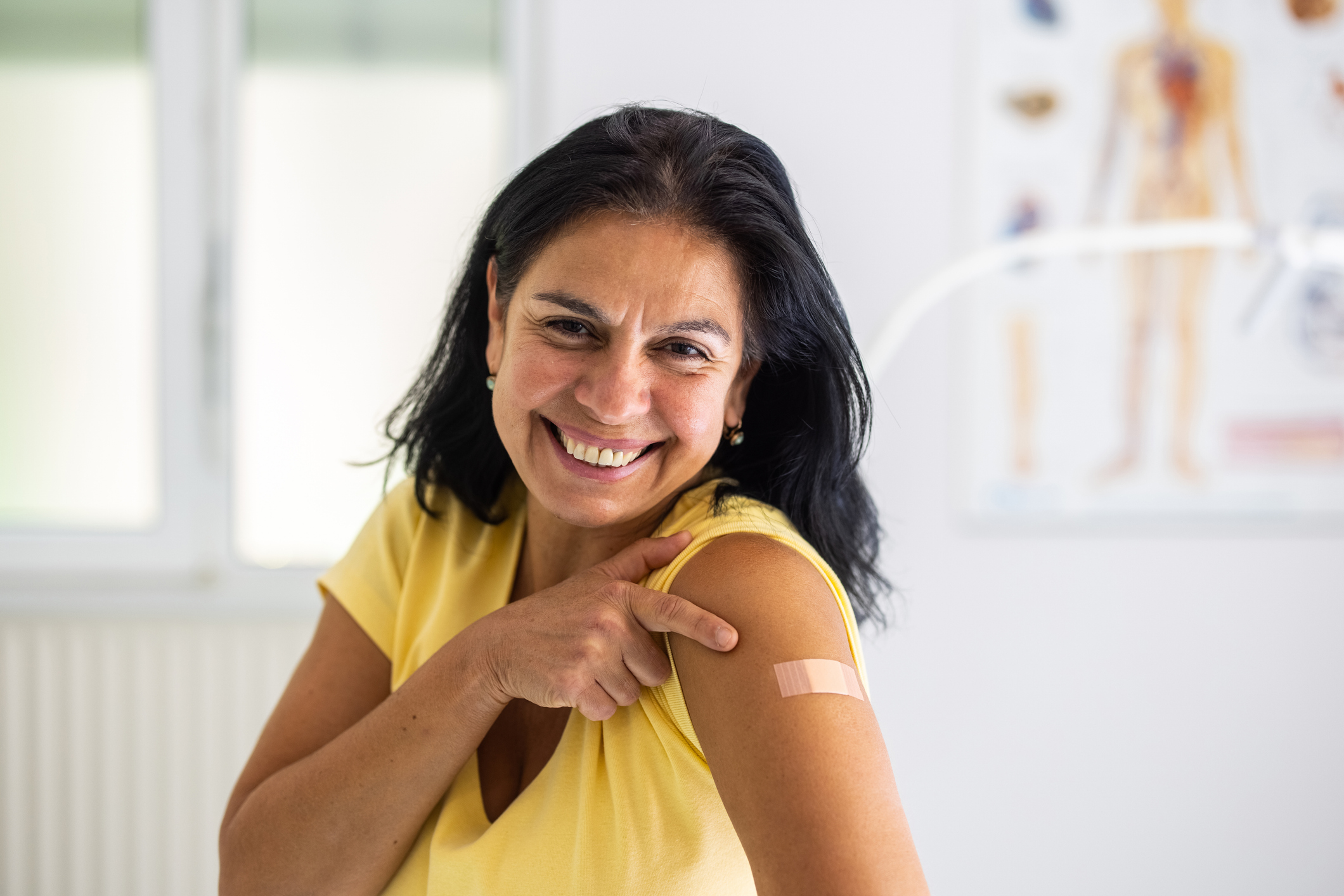 Doctor giving vaccine to patient
