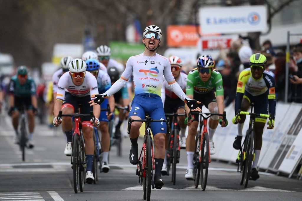 TotalEnergies French rider Mathieu Burgaudeau C celebrates next to TrekSegafredos Danish rider Mads Pedersen L JumboVismas Belgian rider Wout Van Aert CR and IntermarcheWantyGobert Materiauxs Eritrean rider Biniam Girmay Hailu R as he crosses the finish line to win the 6th stage of the 80th Paris Nice cycling race 214 km between Courthezon and Aubagne on March 11 2022 Photo by FRANCK FIFE AFP Photo by FRANCK FIFEAFP via Getty Images