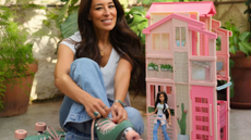 designer joanna gaines photographed for her collaboration with Mattel Inc with her own Barbie doll and barbie townhouse