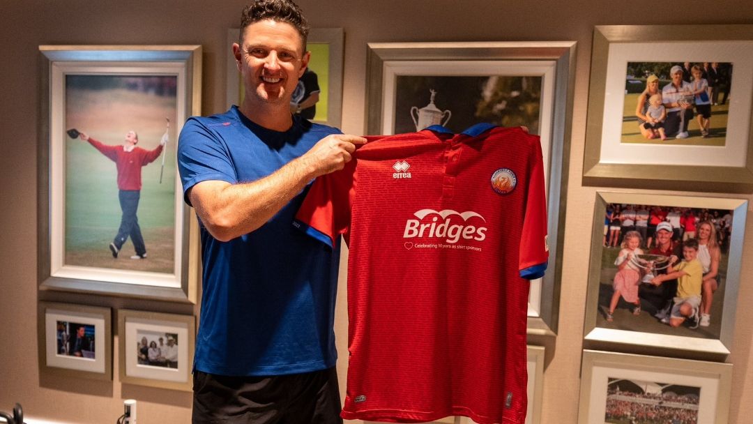 Justin Rose holds an Aldershot Town soccer shirt