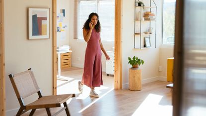 Woman walking around home office and living room on the phone, wearing shoes and doing 10,000 steps at home