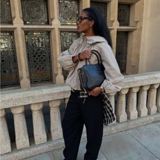 woman wearing windbreaker and flannel shirt