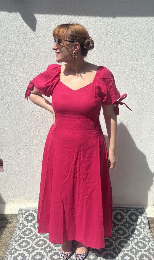 matilda wearing a bright pink dress by mint velvet