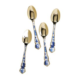 A set of gold teaspoons with white and blue floral handles