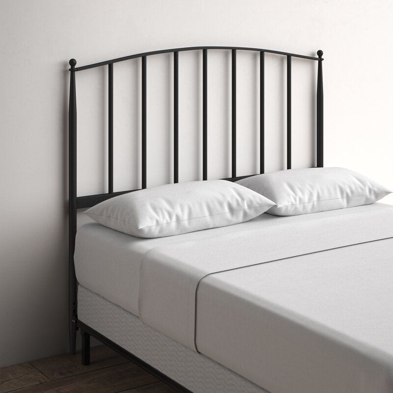 A charcoal colored metal headboard that