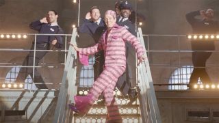Hugh Grant dances on stairs in Paddington 2 musical number.
