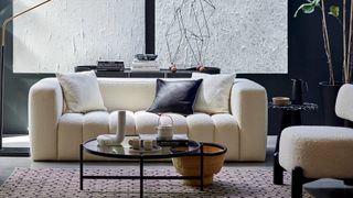 Black living room with white boucle cloud sofa