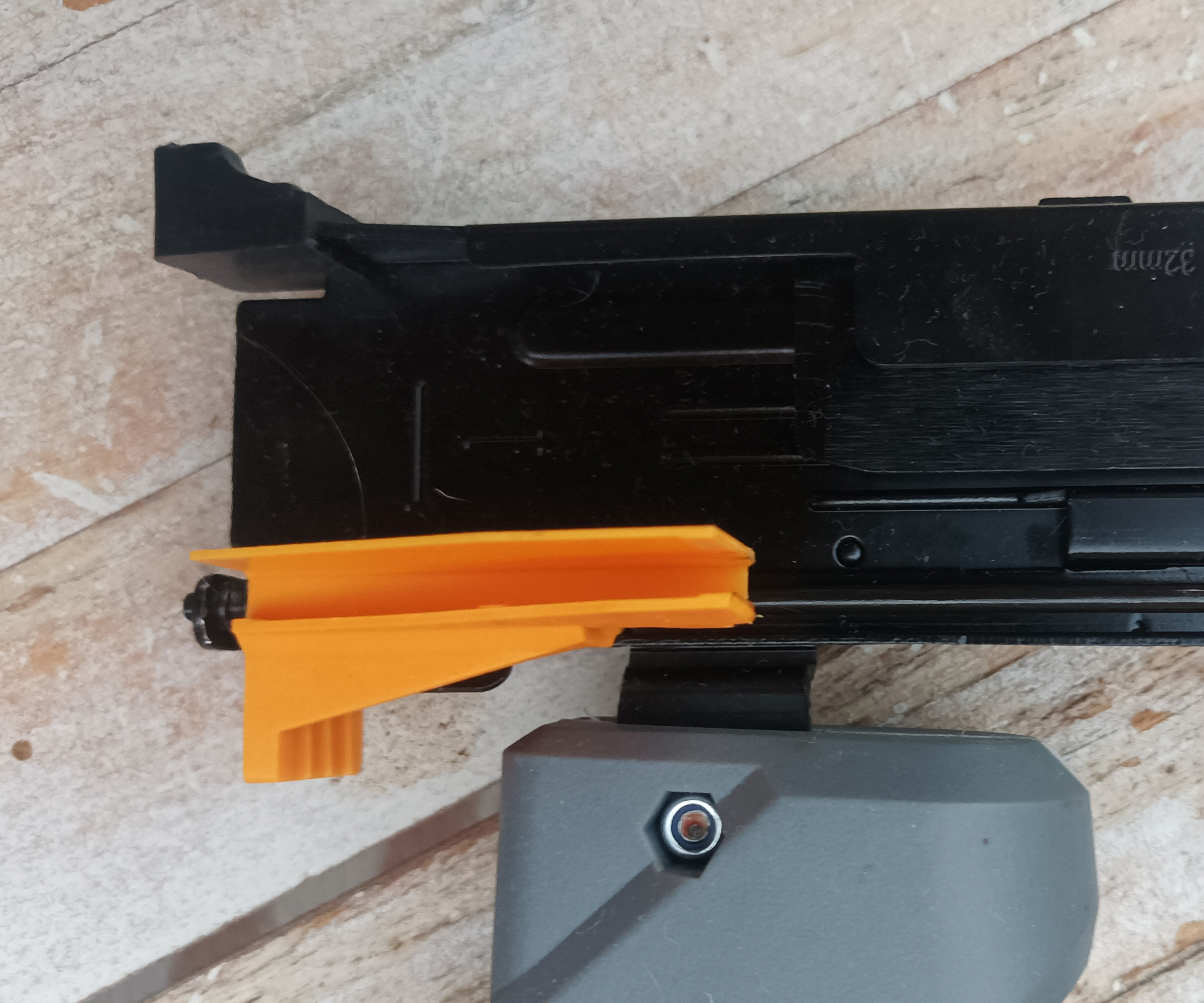 Close up of orange Titan Nail Gun Stapler Fastener retainer