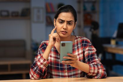 Woman sitting in an office using a smartphone
