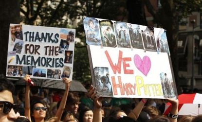 Harry Potter fans hold up signs