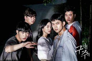 five people stand in front of a black gate as a bright light shines on them, in the korean drama 'save me'