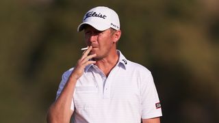 Justin Harding smokes a cigarette during the DP World Tour Championship