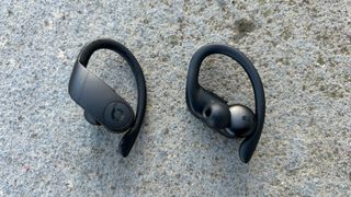Beats Powerbeats Pro buds, with one bud showing ear tip
