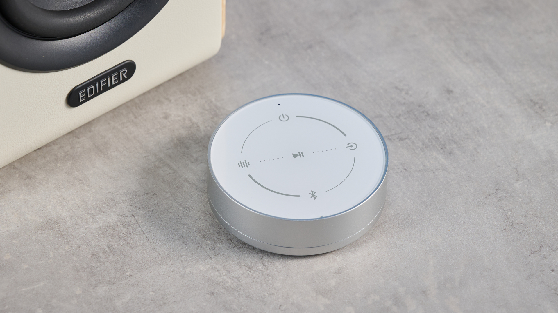 the edifier s880db mkii speakers in white and wood colorway showing the connectivity options, remote control, against a blue background