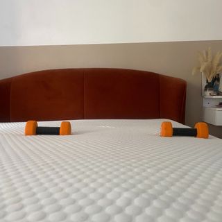DUSK Cool Gel Foam Hybrid mattress in Annie's bedroom on her bed frame with dummbells on bed