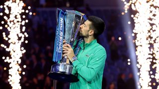 Novak Djokovic kisses the trophy after winning the 2023 Nitto ATP Finals