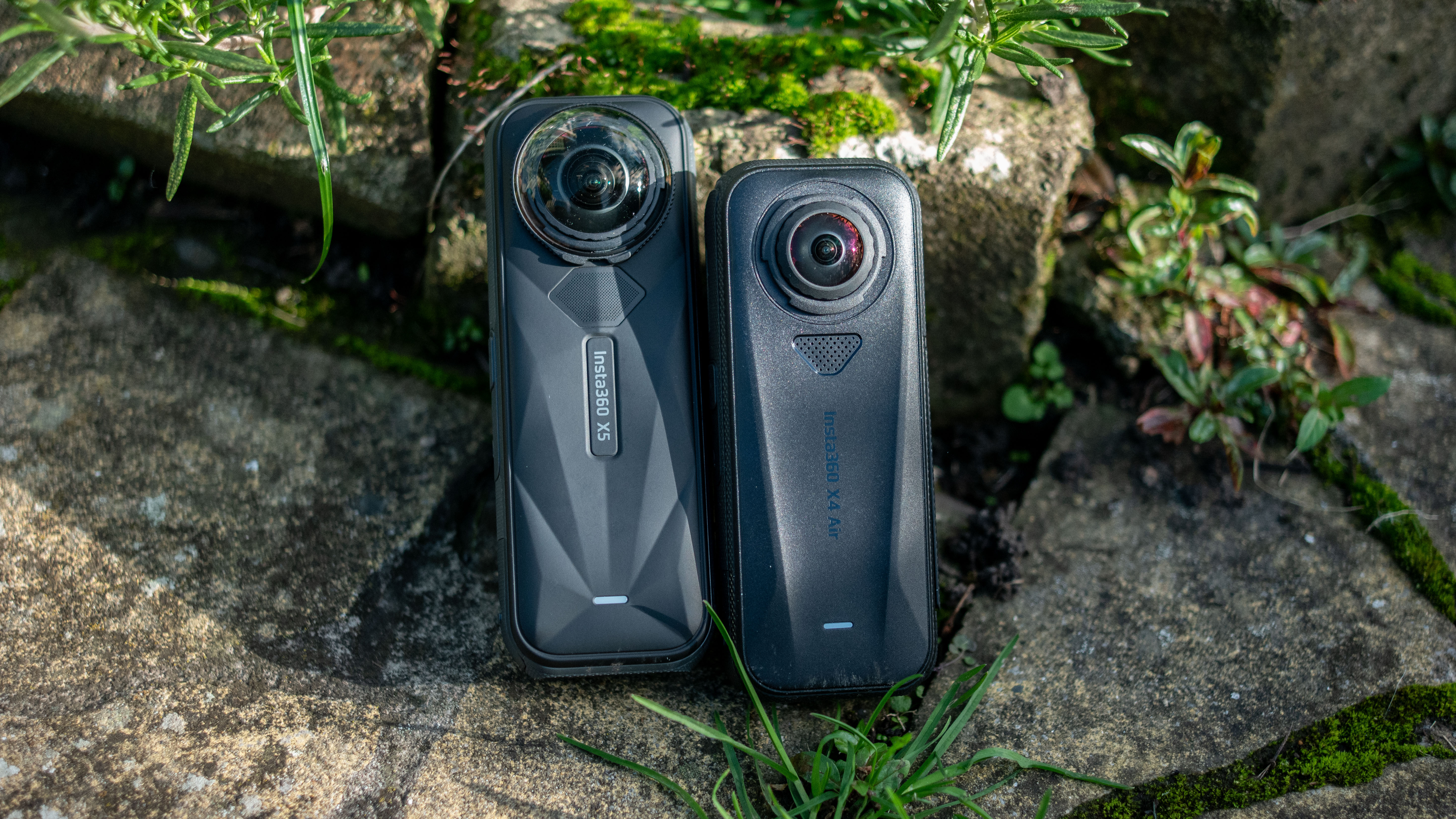 The Insta360 X5 and X4 Air action cameras in an outdoor setting under natural light